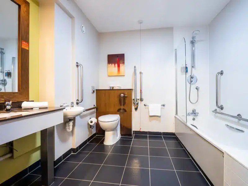 Accessible bathroom with grab bars and modern amenities.