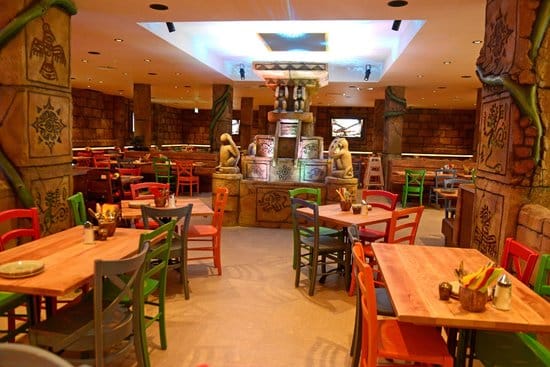 Colorful themed restaurant interior with ancient cultural motifs.