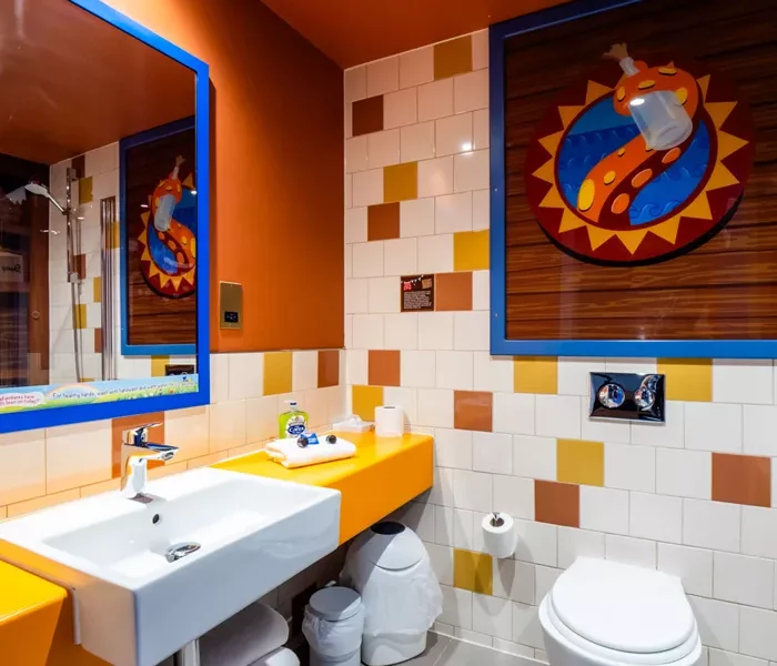 A pirate themed ensuite with yellow, white and brown tiles on the wall