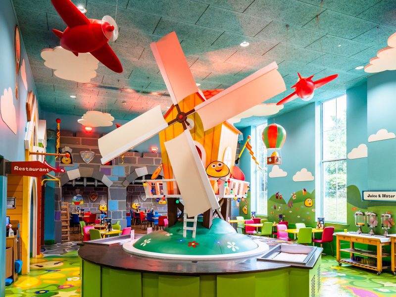 a childrens style restaurant with a decorative windmill as the centre piece of the room