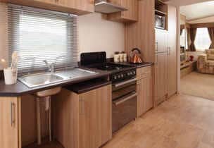 Compact modern kitchen interior with appliances and cabinetry.