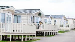 Row of modern mobile homes in coastal campground.