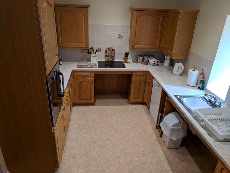 Spacious kitchen with wooden cabinets and modern appliances.