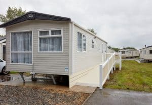 Mobile home with ramp in a caravan park.