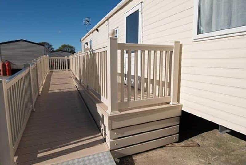 Accessible ramp leading to mobile home entrance.