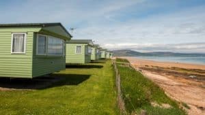 Green beachfront vacation homes overlooking scenic bay.