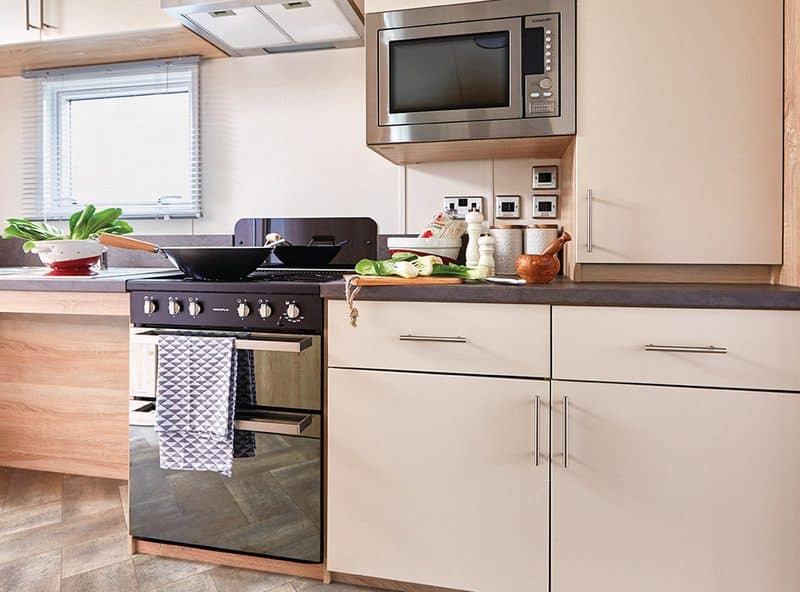 Modern kitchen with stainless steel appliances and wooden cabinets.