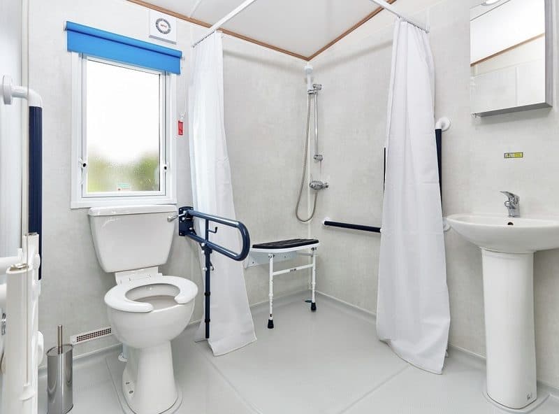 Accessible bathroom with safety features and modern fixtures.