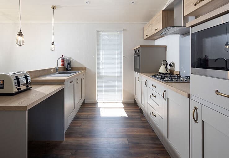 Modern kitchen with wooden countertops and sleek appliances.