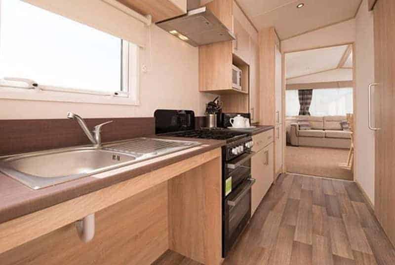 Modern caravan interior with kitchen and living area.