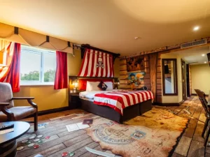 Pirate-themed hotel room with colorful decor and wooden accents.