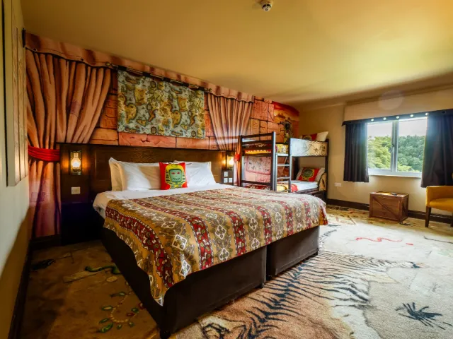 Colorful, themed hotel room with bunk beds and unique decor.