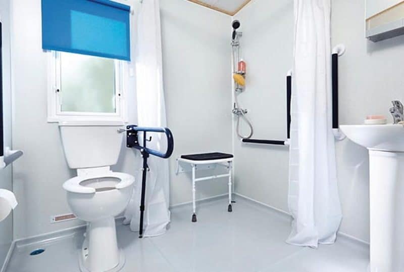 Accessible bathroom with safety aids and shower.