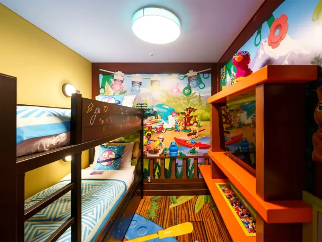 Colorful children's bedroom with bunk beds and playful decor.