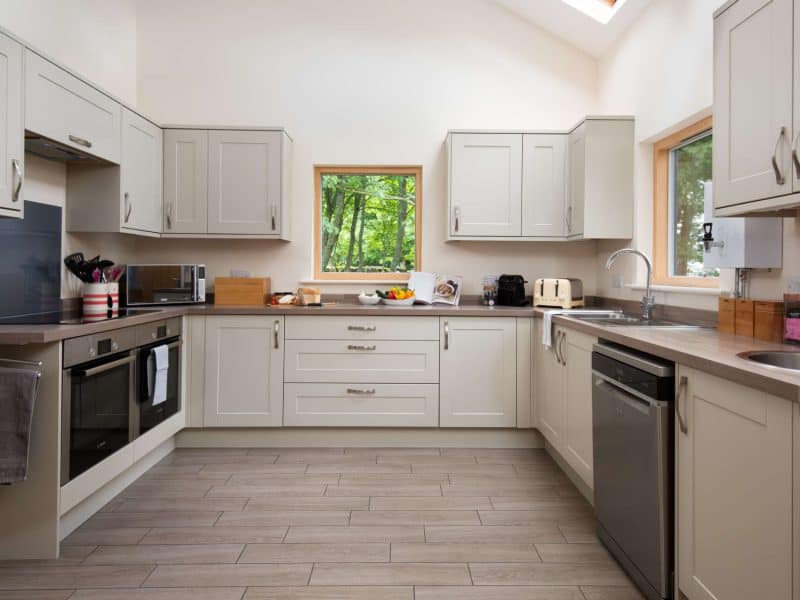 Modern kitchen with white cabinets and natural light.