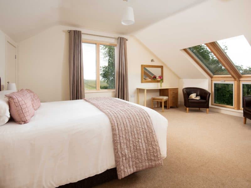 Bright, cozy attic bedroom with scenic window view.