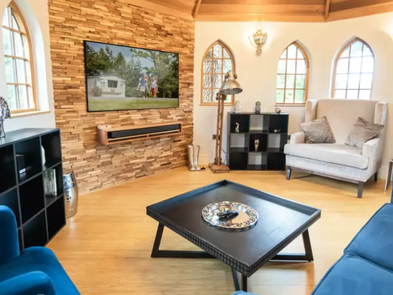 Elegant living room with stone wall and modern furnishings.