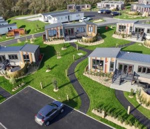 Aerial view of modern mobile home park with green lawns.