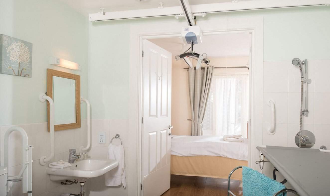 Accessible hospital bathroom with supportive equipment.