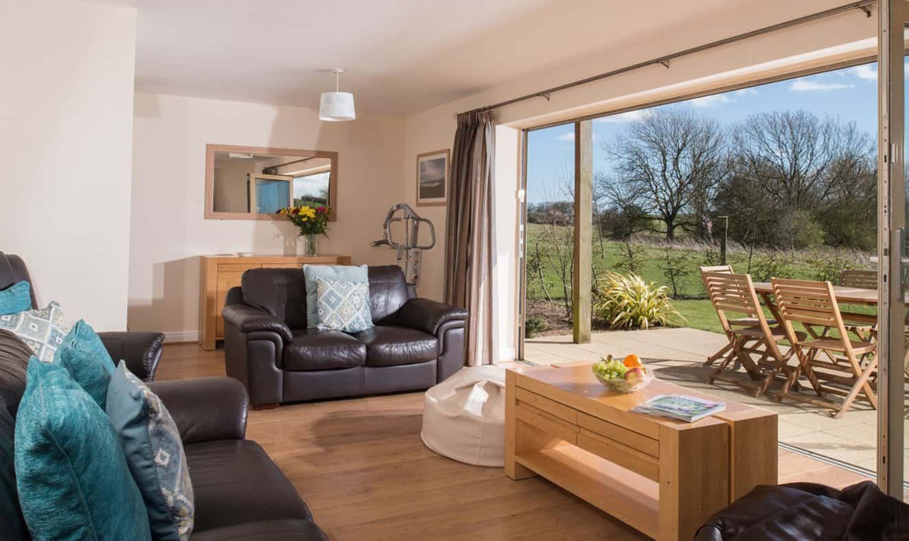 Bright living room opening to sunny garden patio.