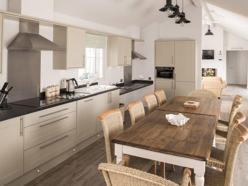 Spacious modern kitchen with dining area and neutral tones.