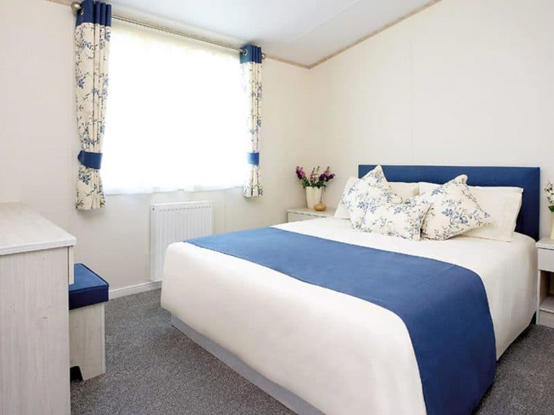 Bright, cozy bedroom with blue and white decor.