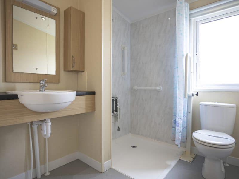 Modern bathroom interior with sink, toilet, and shower.