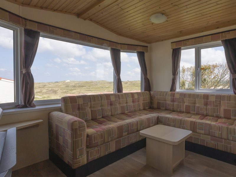 Cozy beach house interior with scenic dune view.