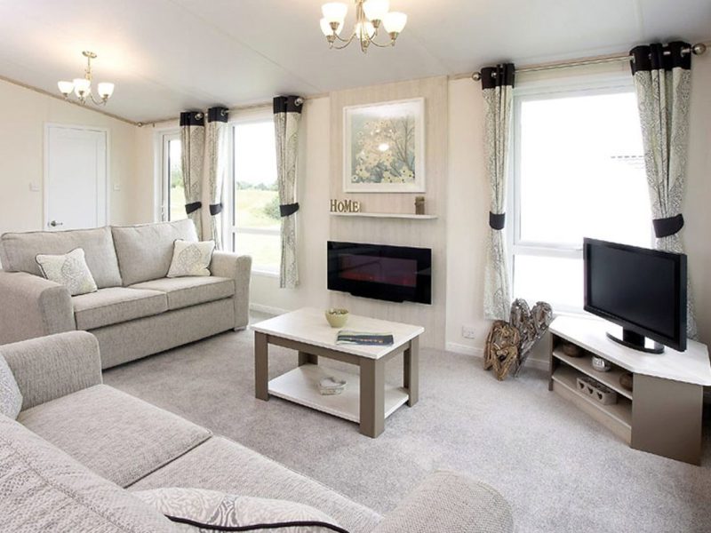 Spacious, modern living room with neutral colors and decor.