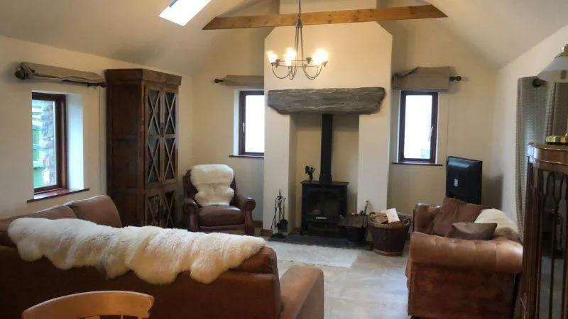 cosy living room with brown seating and log burner.