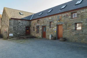 Brick farmhouse with wooden doors and windows