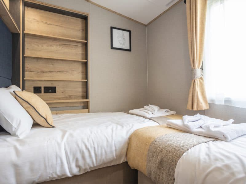 Cozy hotel room with wooden shelves and elegant decor.