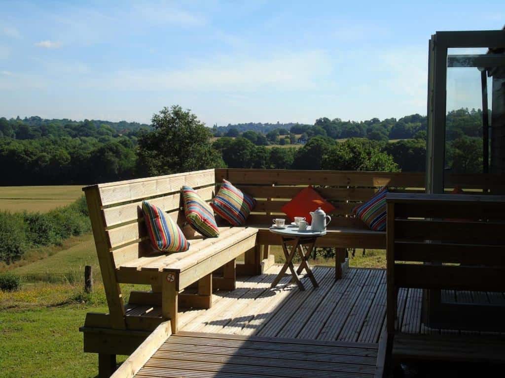 Scenic outdoor deck with colorful pillows and teapot