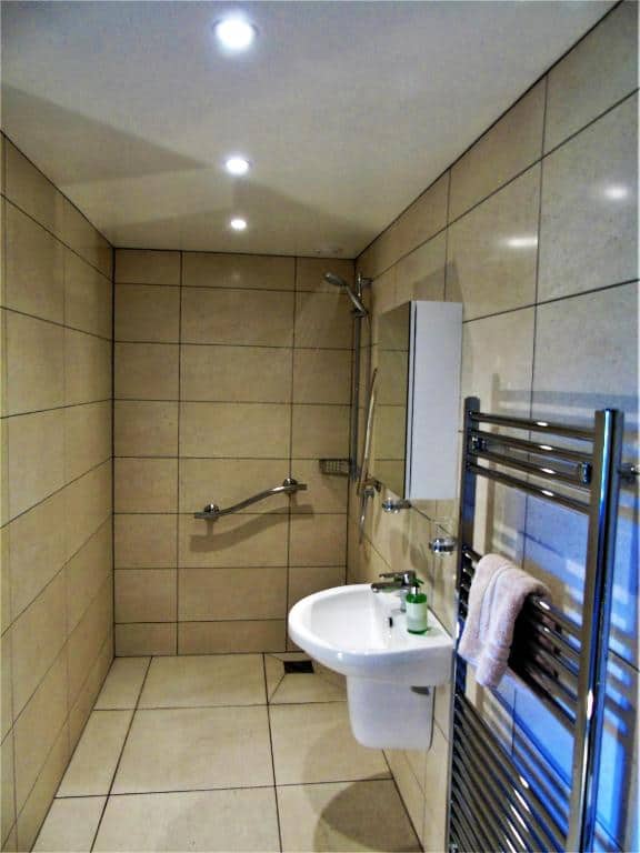 Modern tiled bathroom with shower and sink