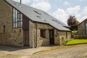 Stone Barn Coversion with light brown brick and grey slate roof