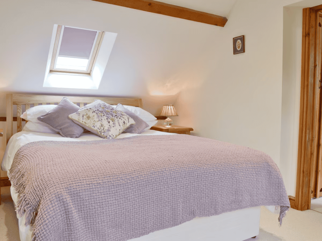 Cozy attic bedroom with skylight and wooden accents