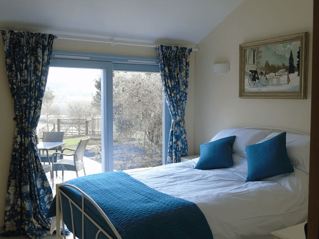 Cozy bedroom with open patio doors and scenic view