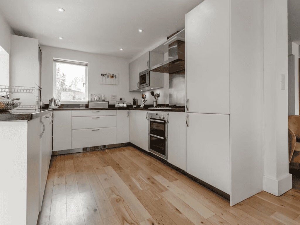 Modern kitchen interior with wooden floors and appliances