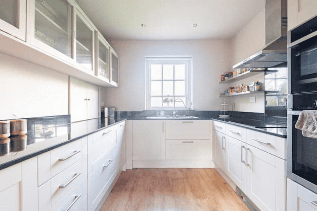 Modern kitchen with white cabinets and black countertops