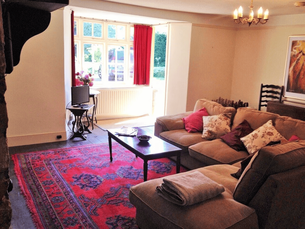 Cozy living room with red curtains and sectional sofa