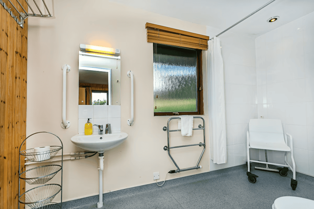 Accessible bathroom with safety handles and shower chair