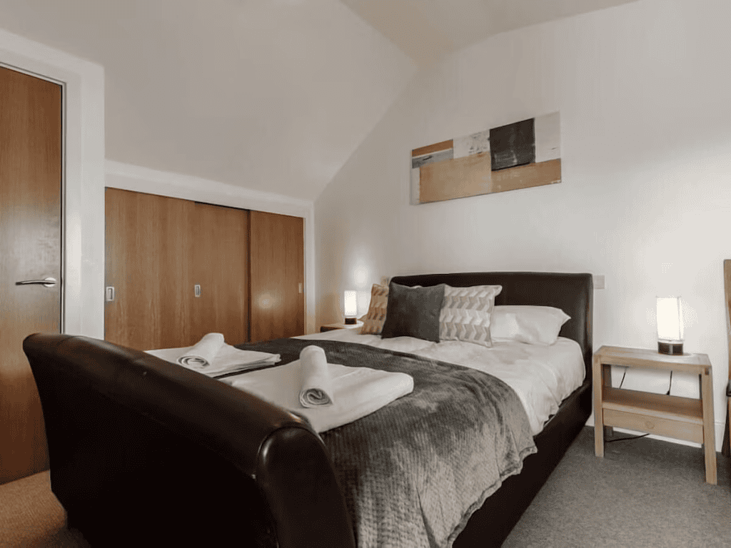 Modern hotel room with cozy double bed and lamps