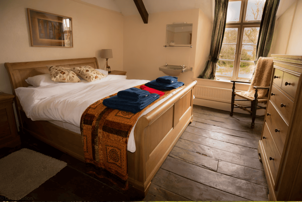 Cozy bedroom with wooden furniture and scenic window view