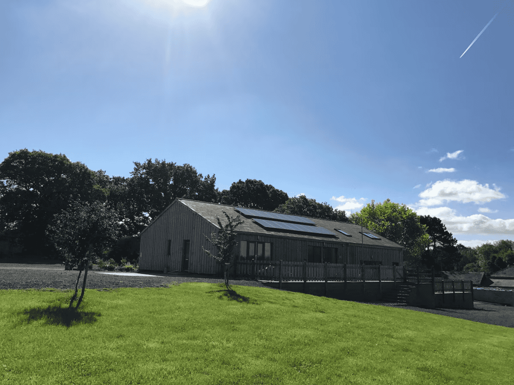 Modern barn conversion under sunny blue sky