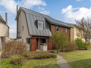 Modern house with gray roof and wooden accents