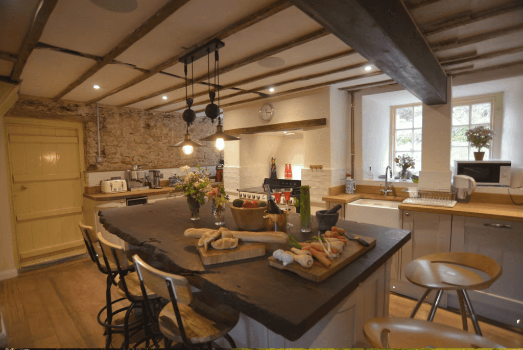 Rustic kitchen interior with wooden beams and stone wall