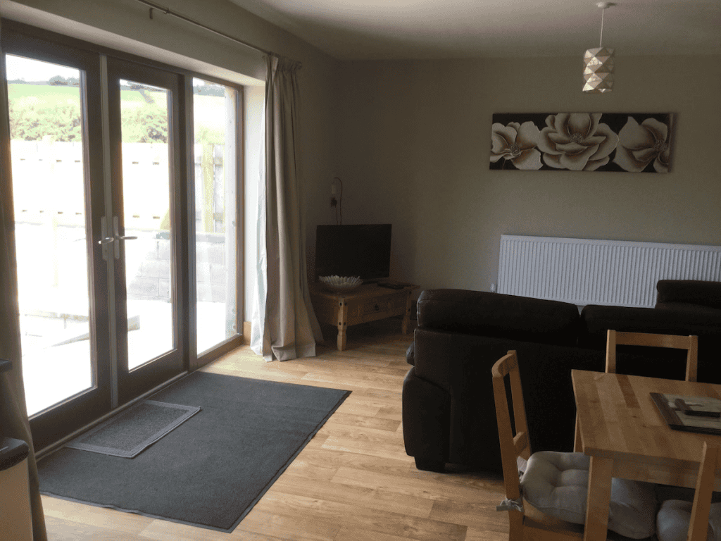 Cozy living room with wooden floor and patio doors