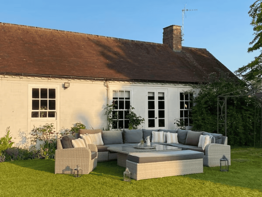 Charming cottage with outdoor seating area in garden