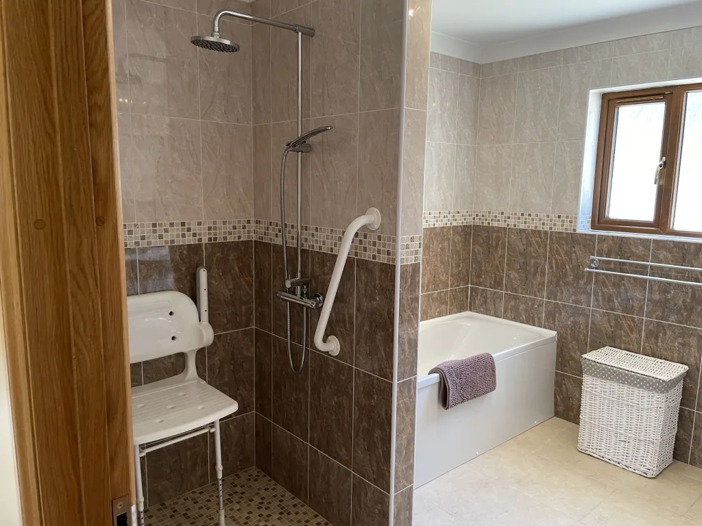 Accessible bathroom with shower chair and bathtub