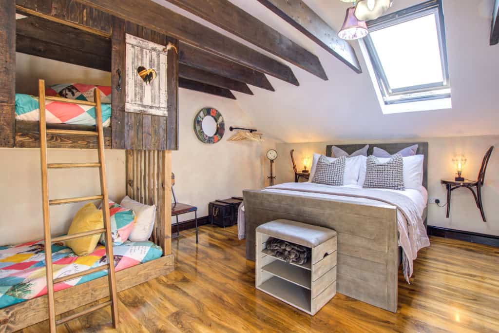 Cozy, rustic bedroom with bunk bed and queen-size bed